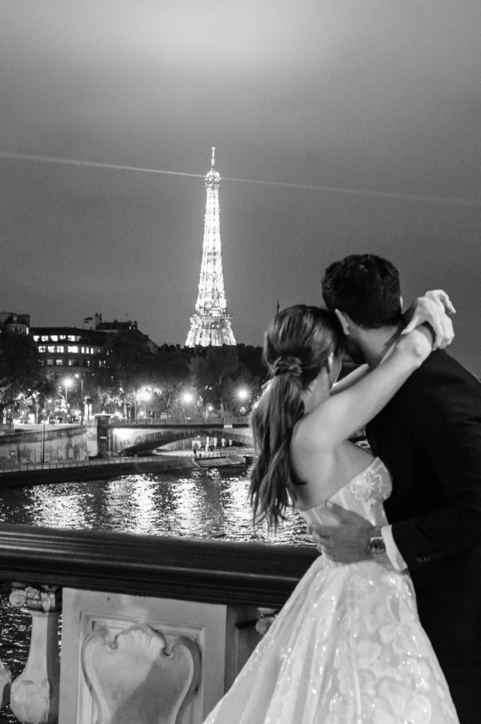 bride and groom looking at the Eiffel Tower in France during my business trip to France